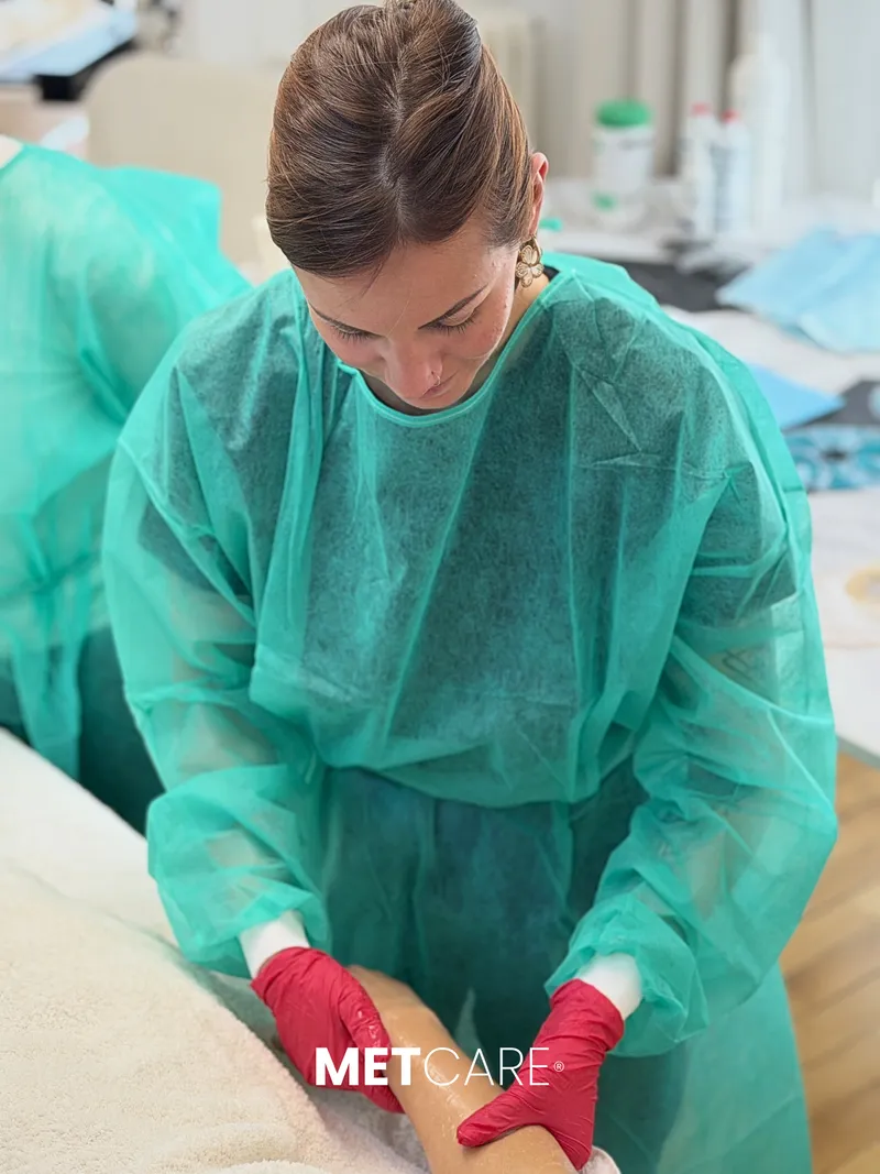 Praticienne en blouse METCARE® pendant sa mise en pratique